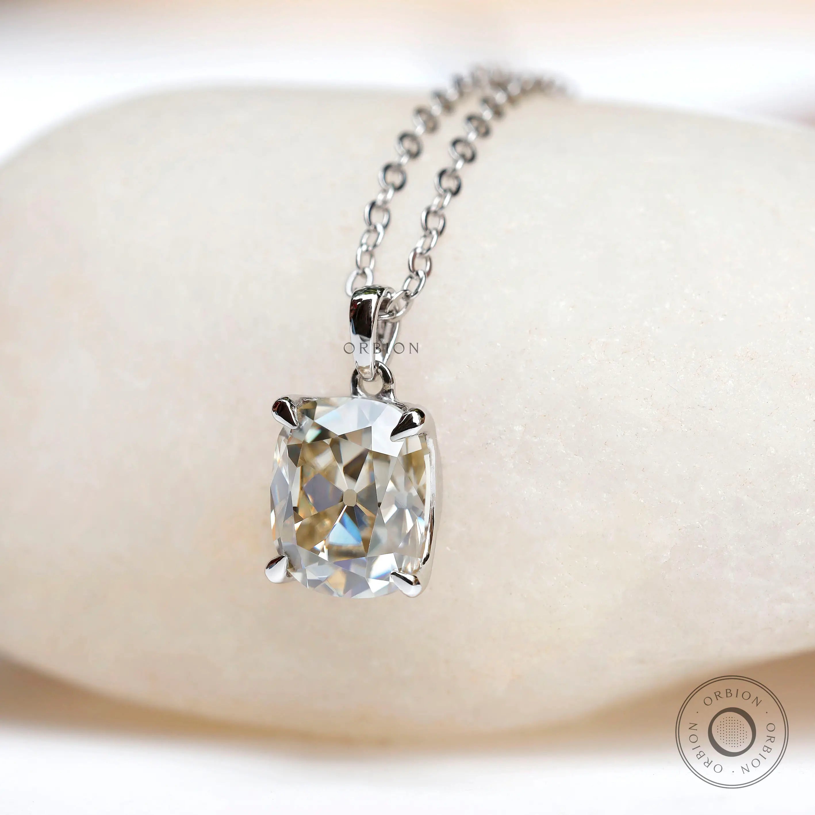 Cushion cut solitaire pendant with four prong setting on chain