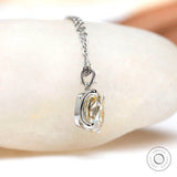 Side profile of moissanite pendant showing prong setting and depth