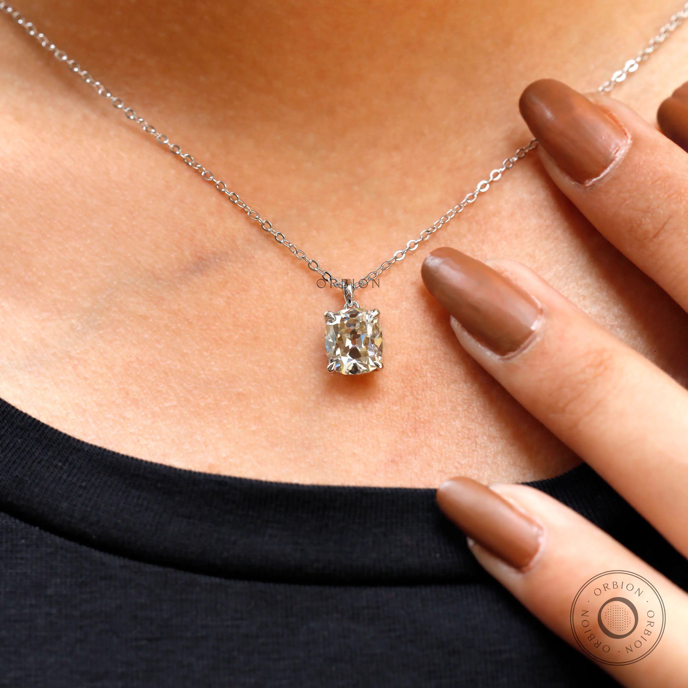 Moissanite pendant necklace worn on neck with natural styling