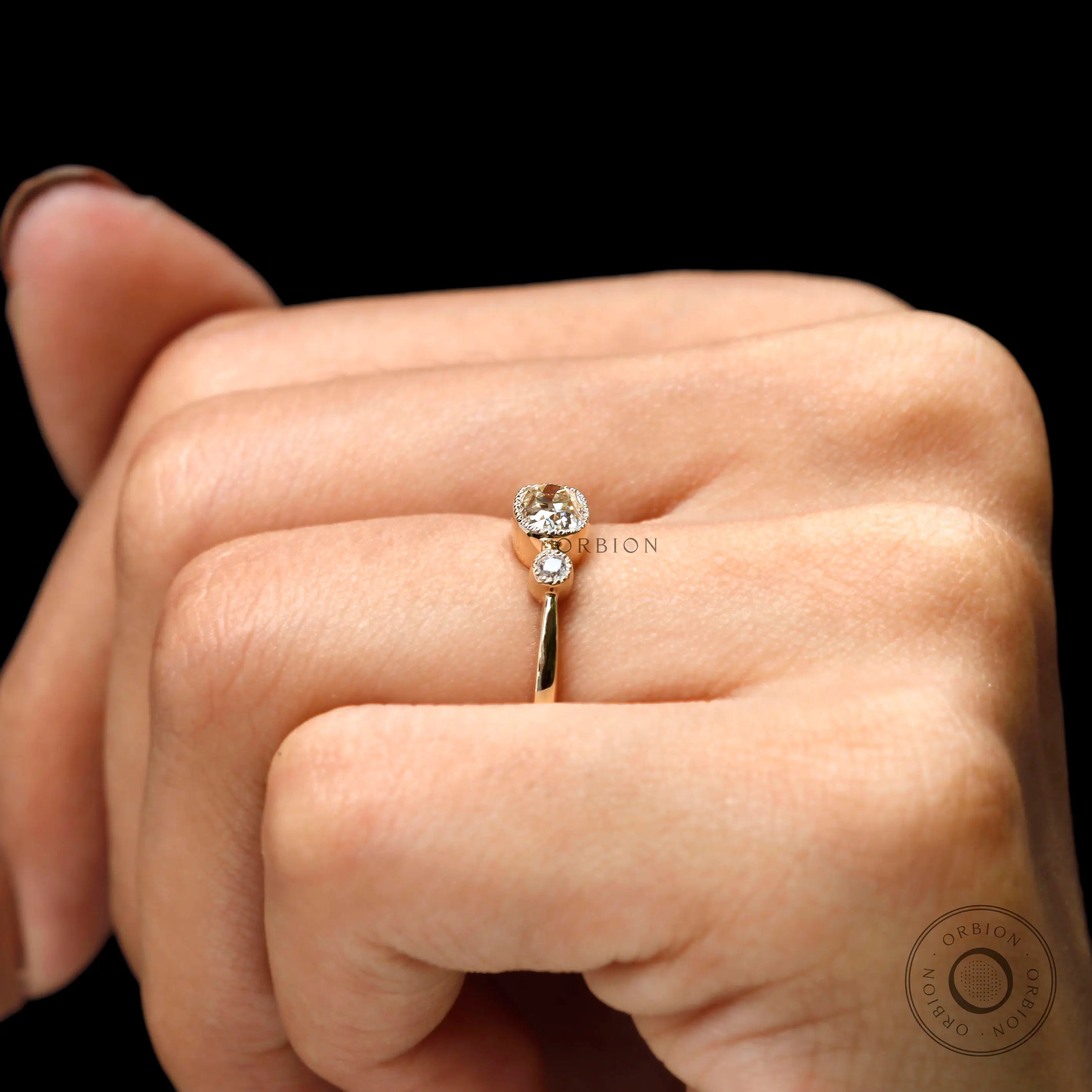 Yellow gold moissanite ring with cushion center and round side stones