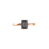 Front view of emerald cut grey moissanite solitaire ring in rose gold.