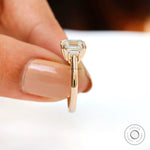 Straight side view highlighting double claw prongs and slim polished gold band