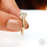 Straight side view highlighting double claw prongs and slim polished gold band