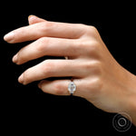 Lifestyle on-hand view of Asscher moissanite ring in warm yellow gold