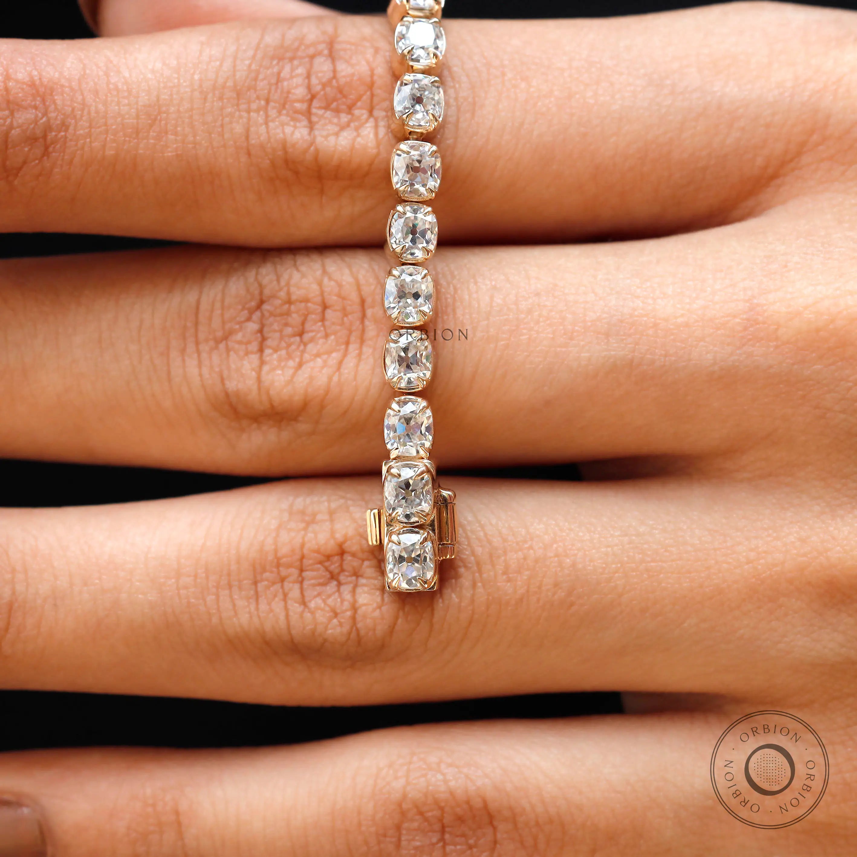 Closeup of antique OMC cushion moissanite links in yellow gold
