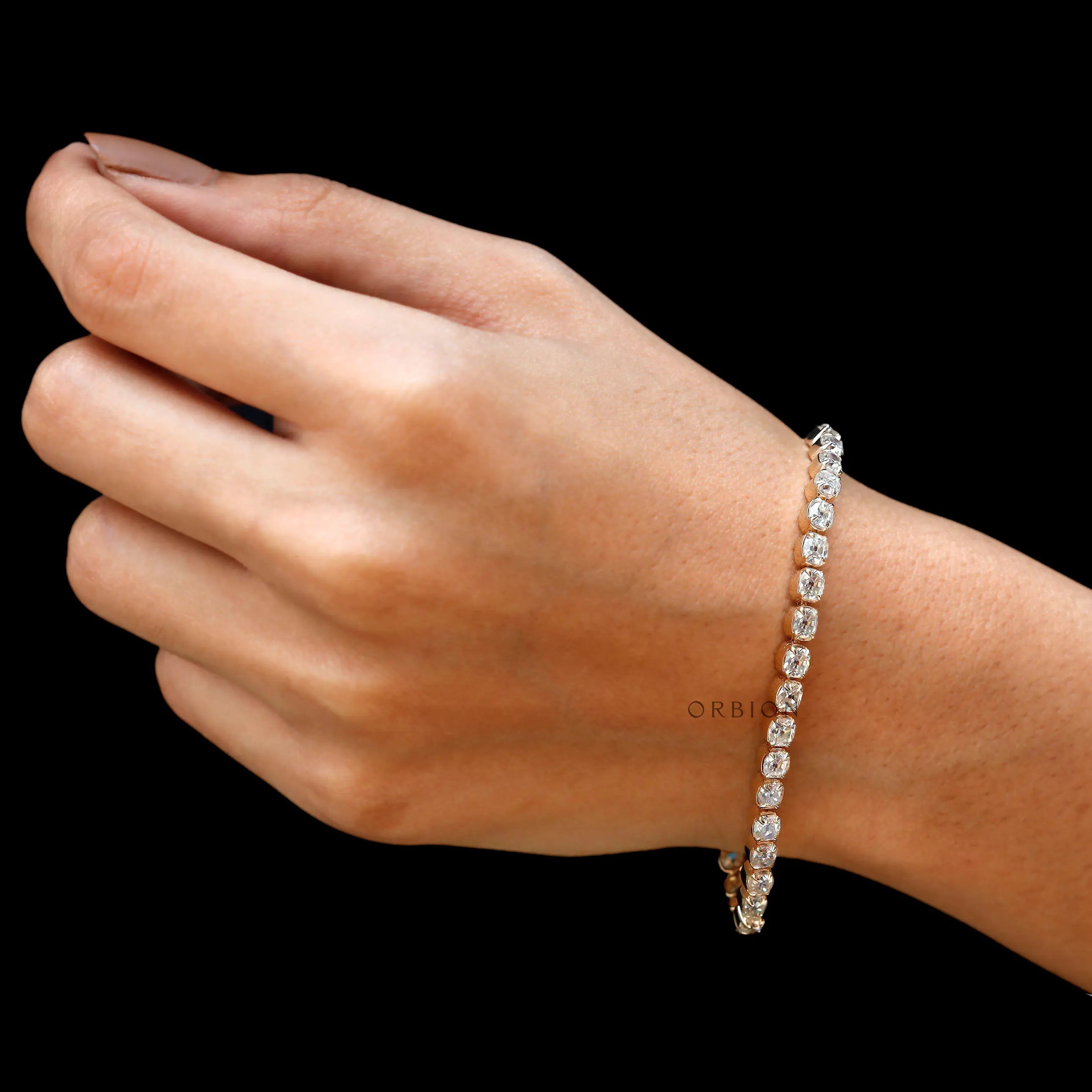 Full wrist shot of dainty OMC moissanite tennis bracelet