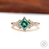 Front view of the princess-cut green moissanite engagement ring.