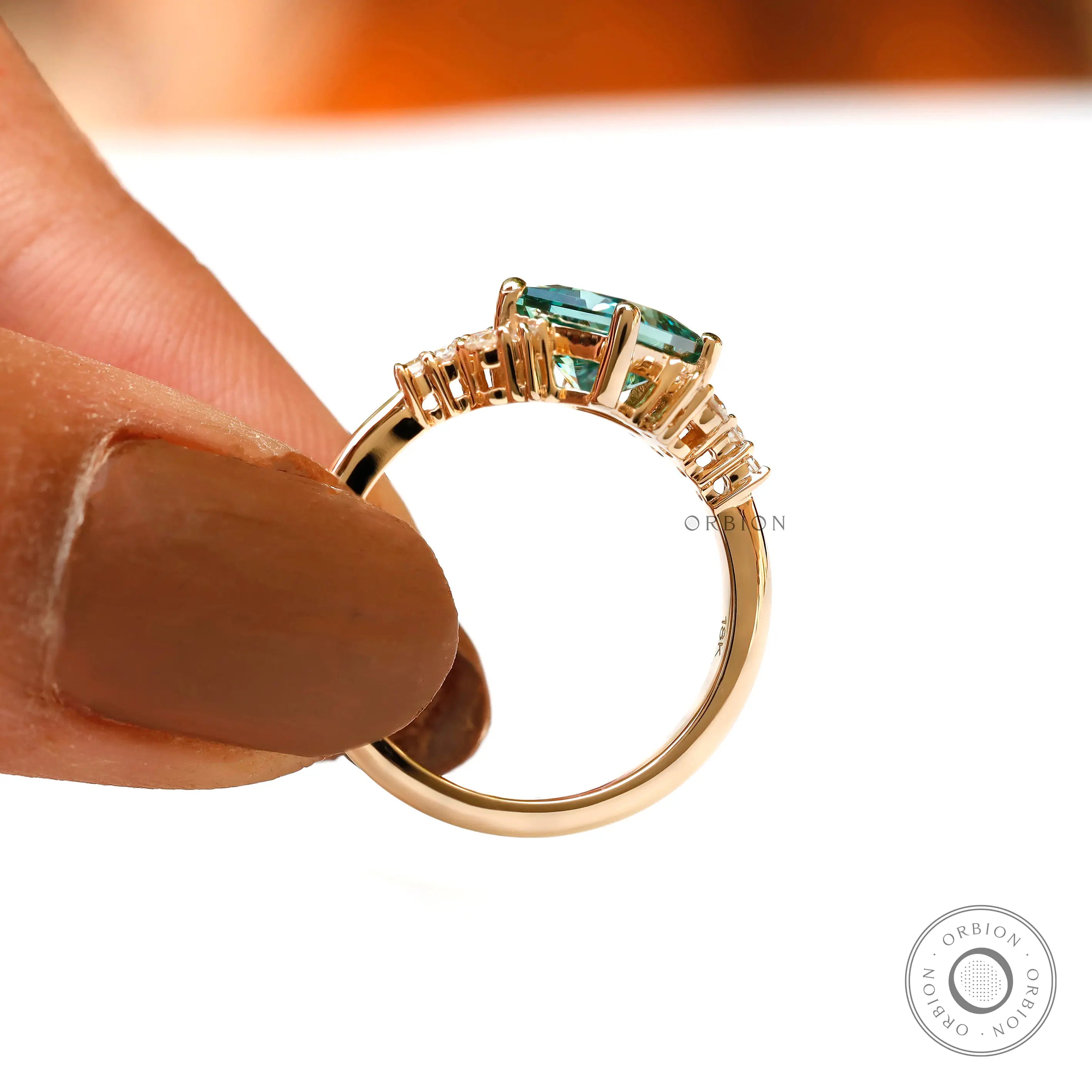 Side profile highlighting green moissanite and diamond accents.