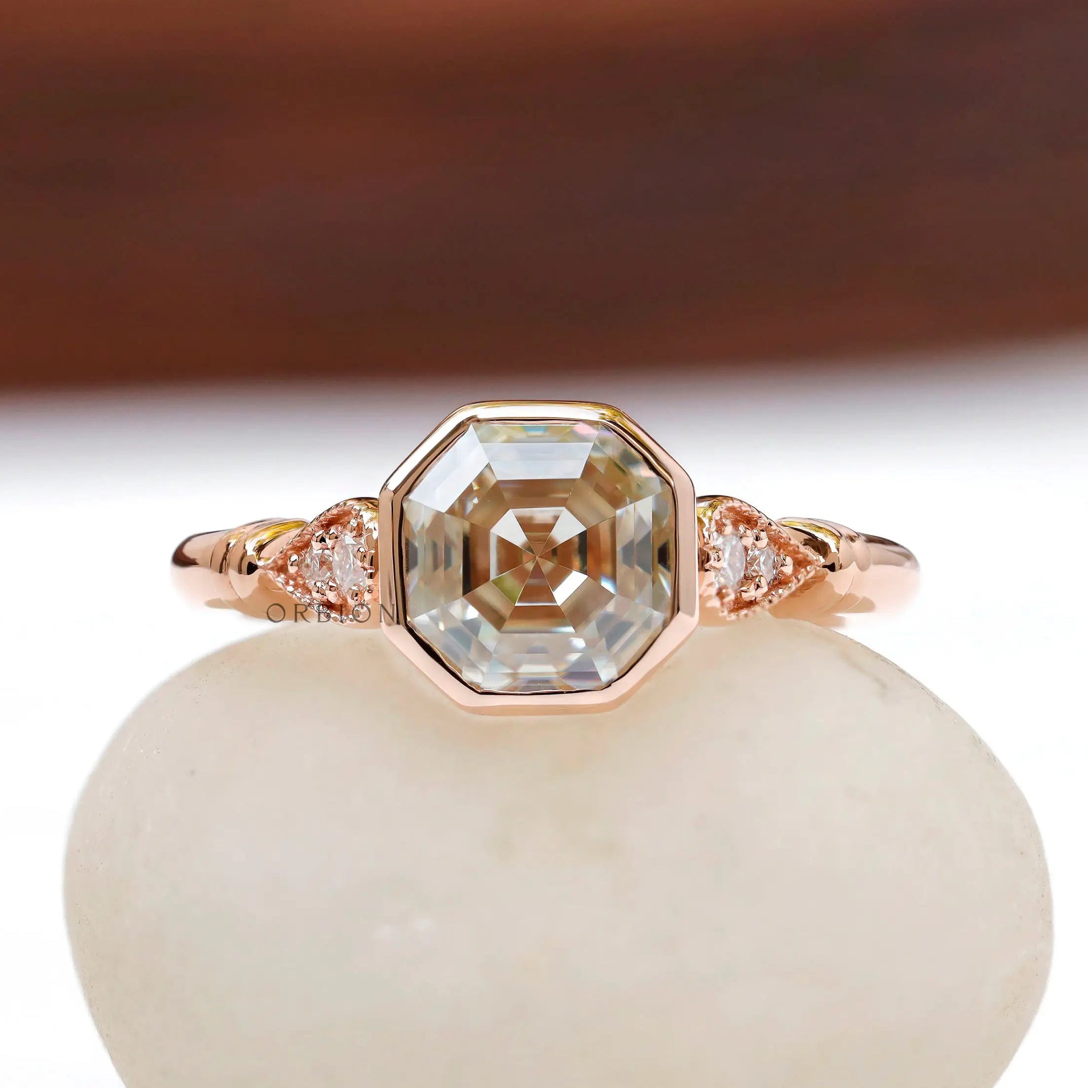 Front view of Octavia Asscher cut ring with off-white moissanite