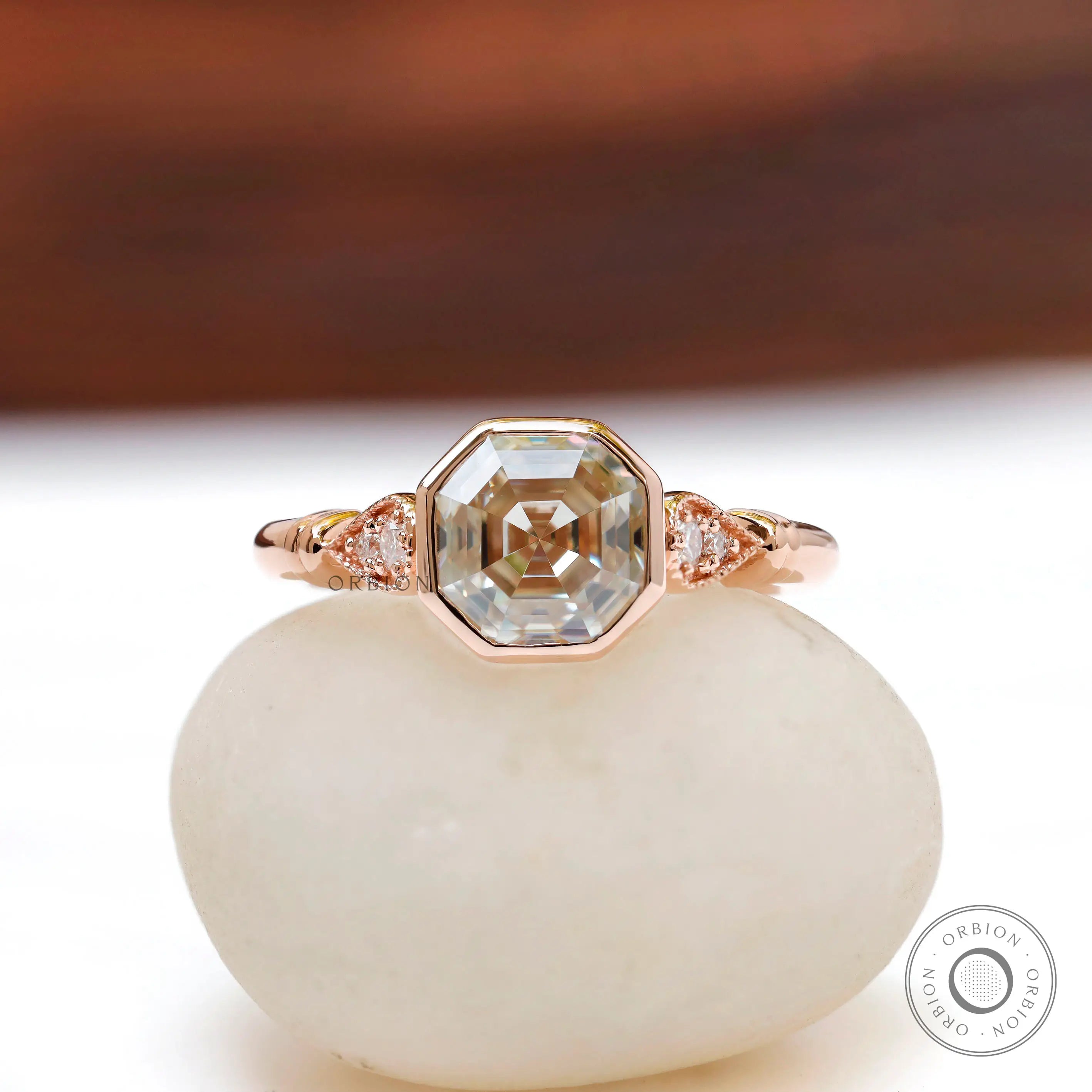 Front view of Octavia Asscher cut ring with off-white moissanite