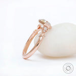 Profile view showing bezel-set octavia ring in 14K rose gold