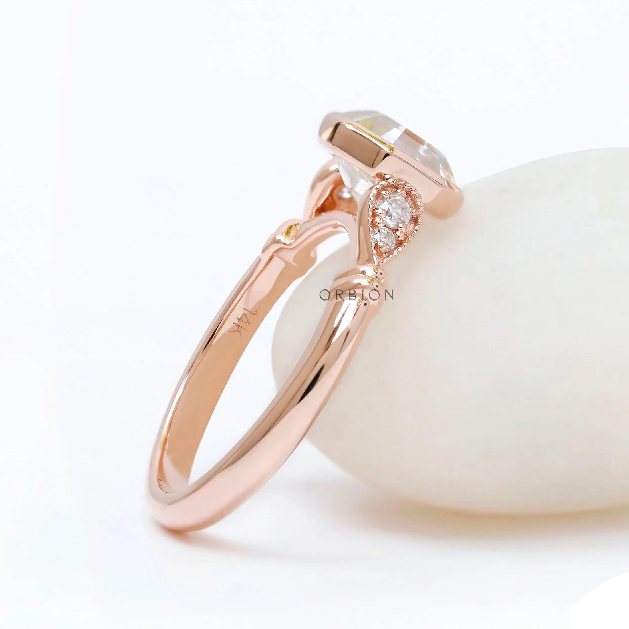 Profile view showing bezel-set octavia ring in 14K rose gold