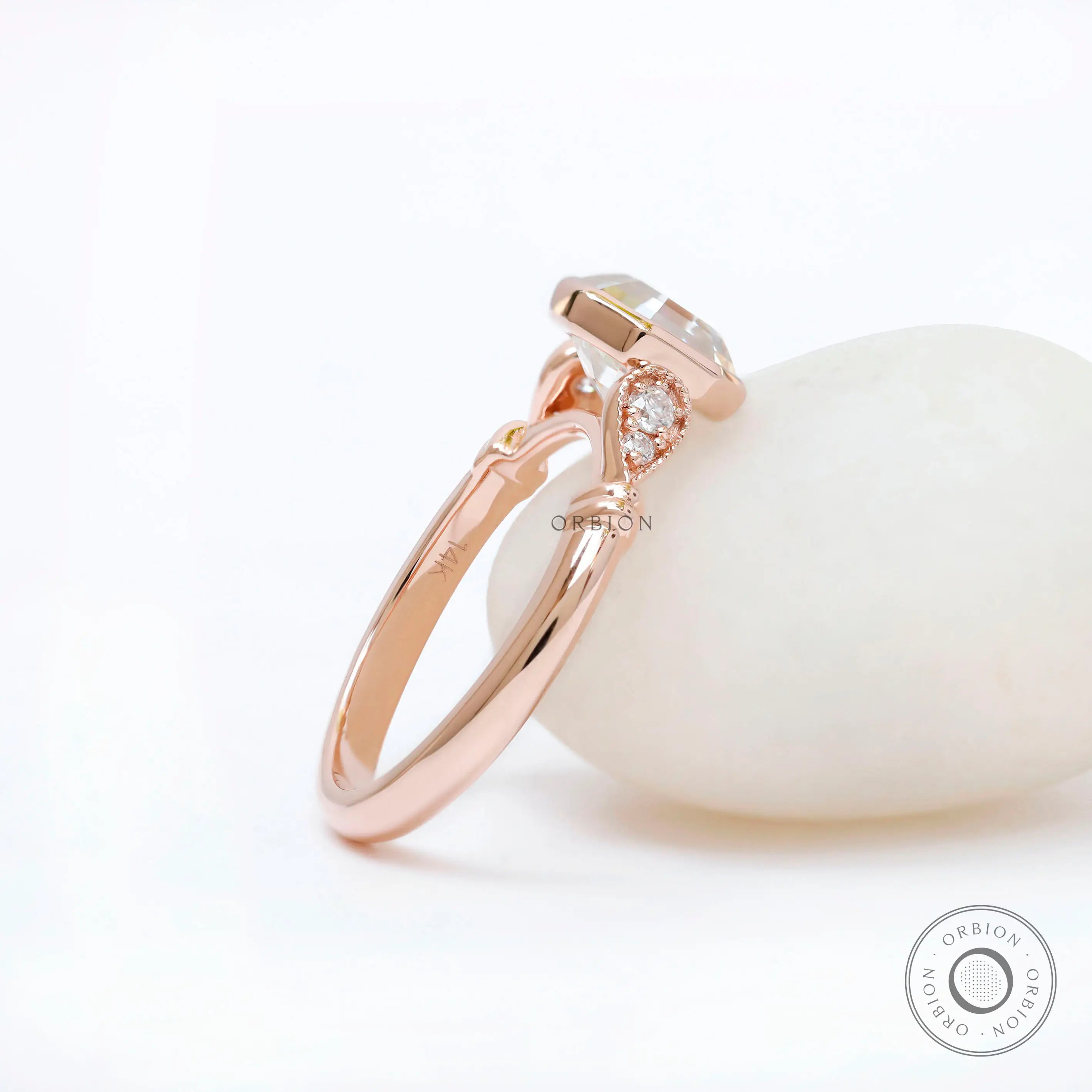 Profile view showing bezel-set octavia ring in 14K rose gold