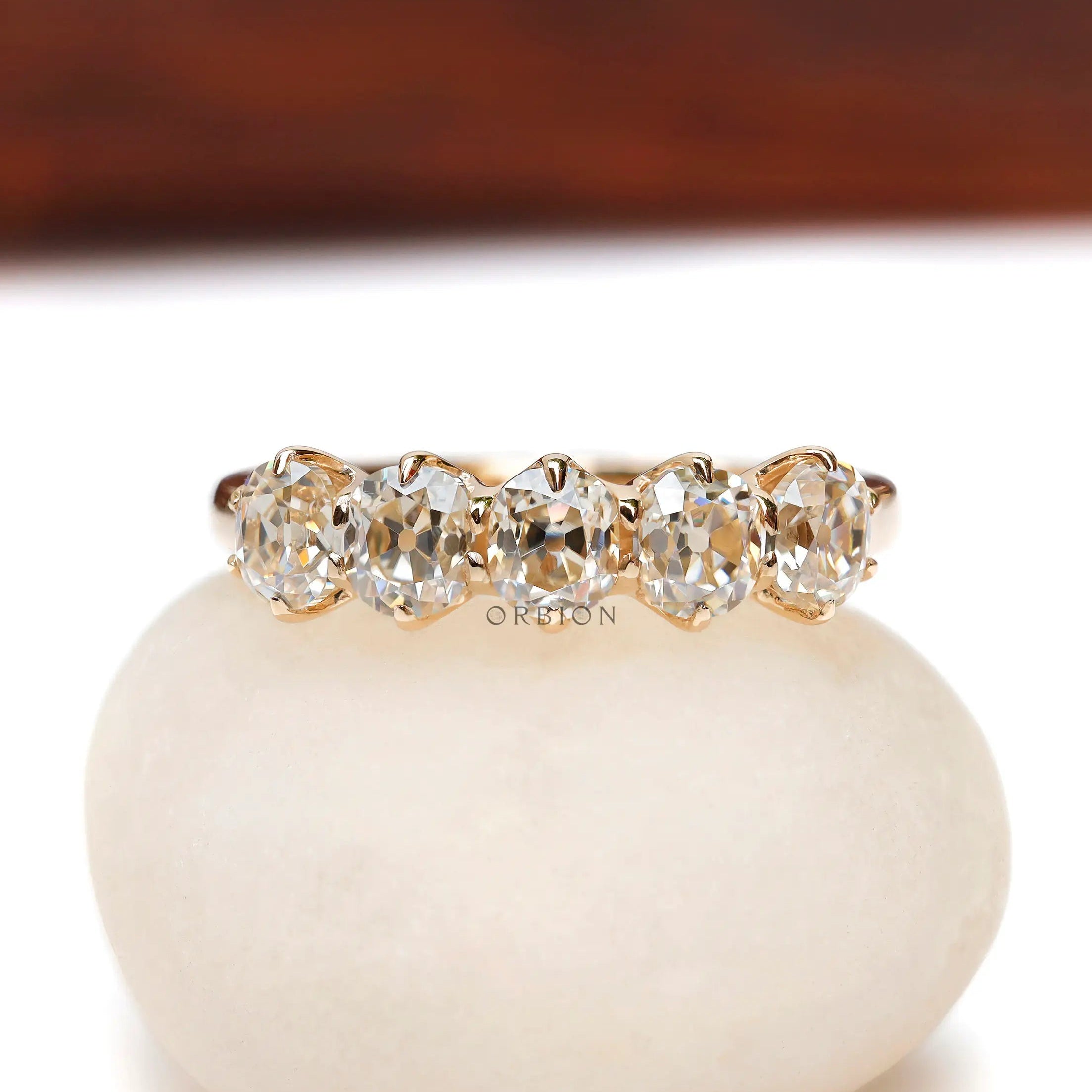 Front view of five stone old mine cut cushion moissanite band