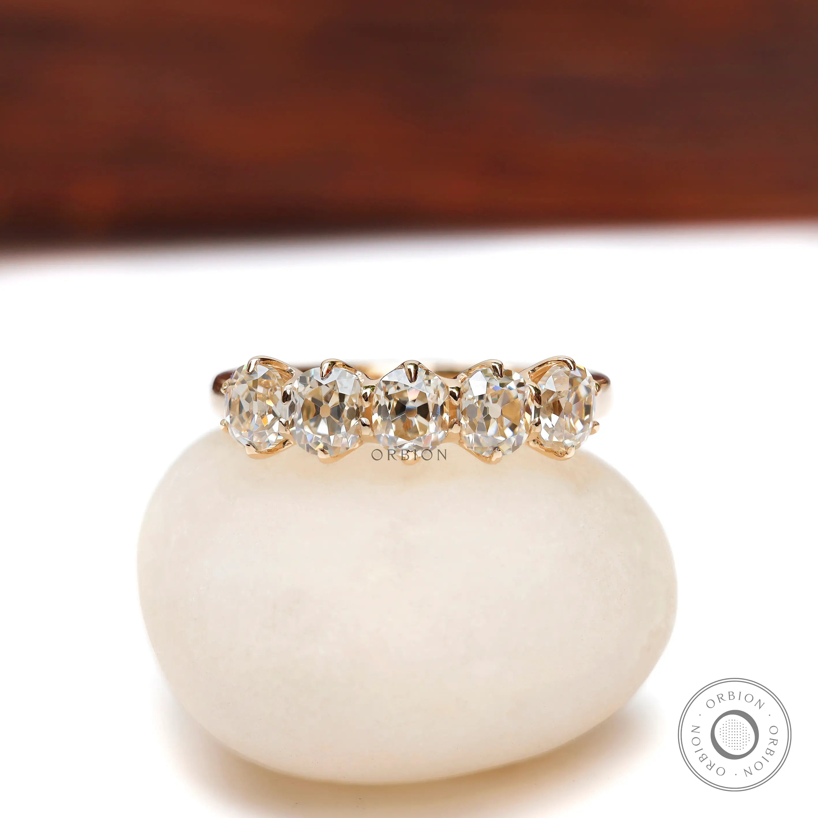 Front view of five stone old mine cut cushion moissanite band