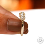 Held underside view showing open gallery and prong structure in yellow gold