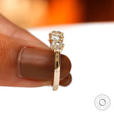 Held underside view showing open gallery and prong structure in yellow gold