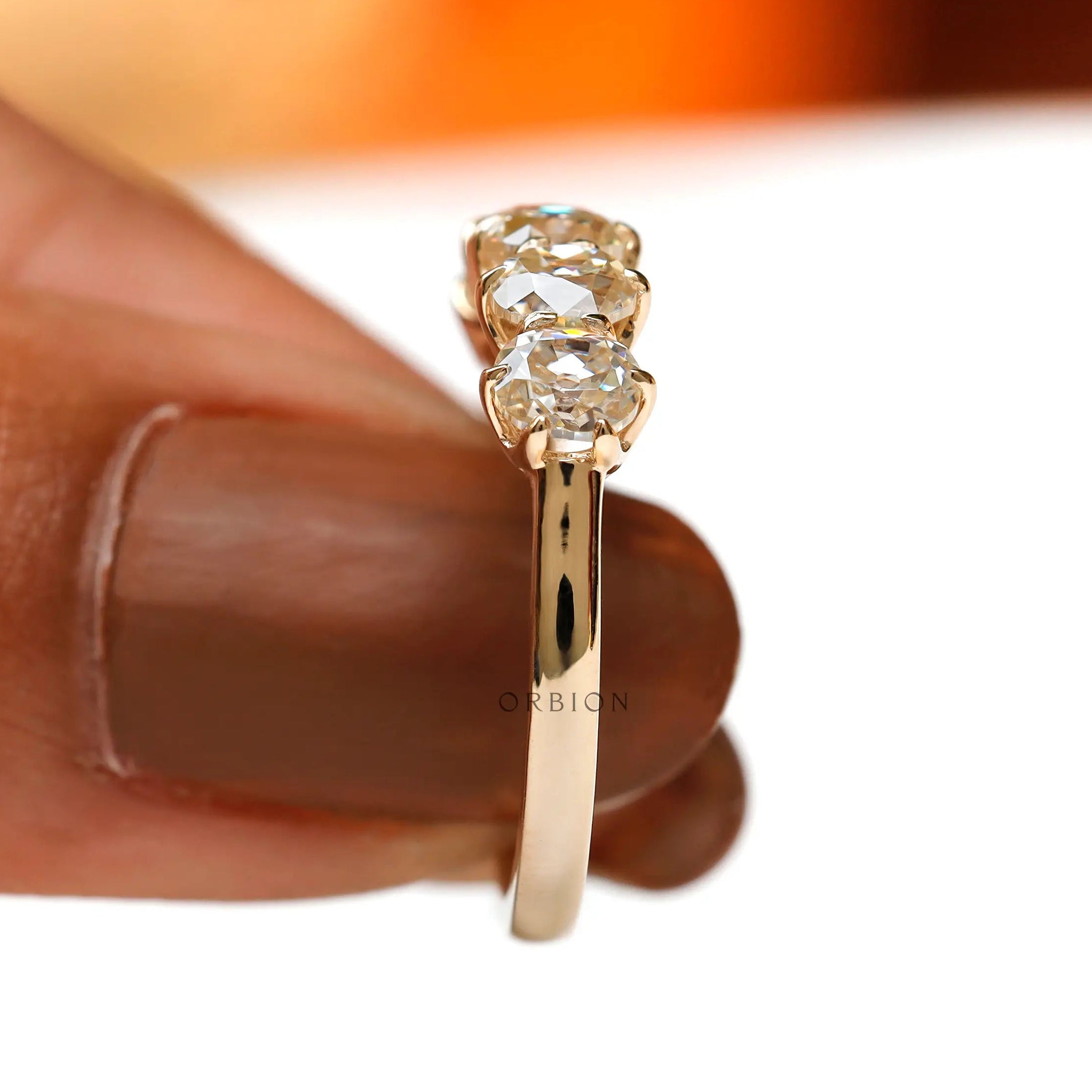Held underside view showing open gallery and prong structure in yellow gold