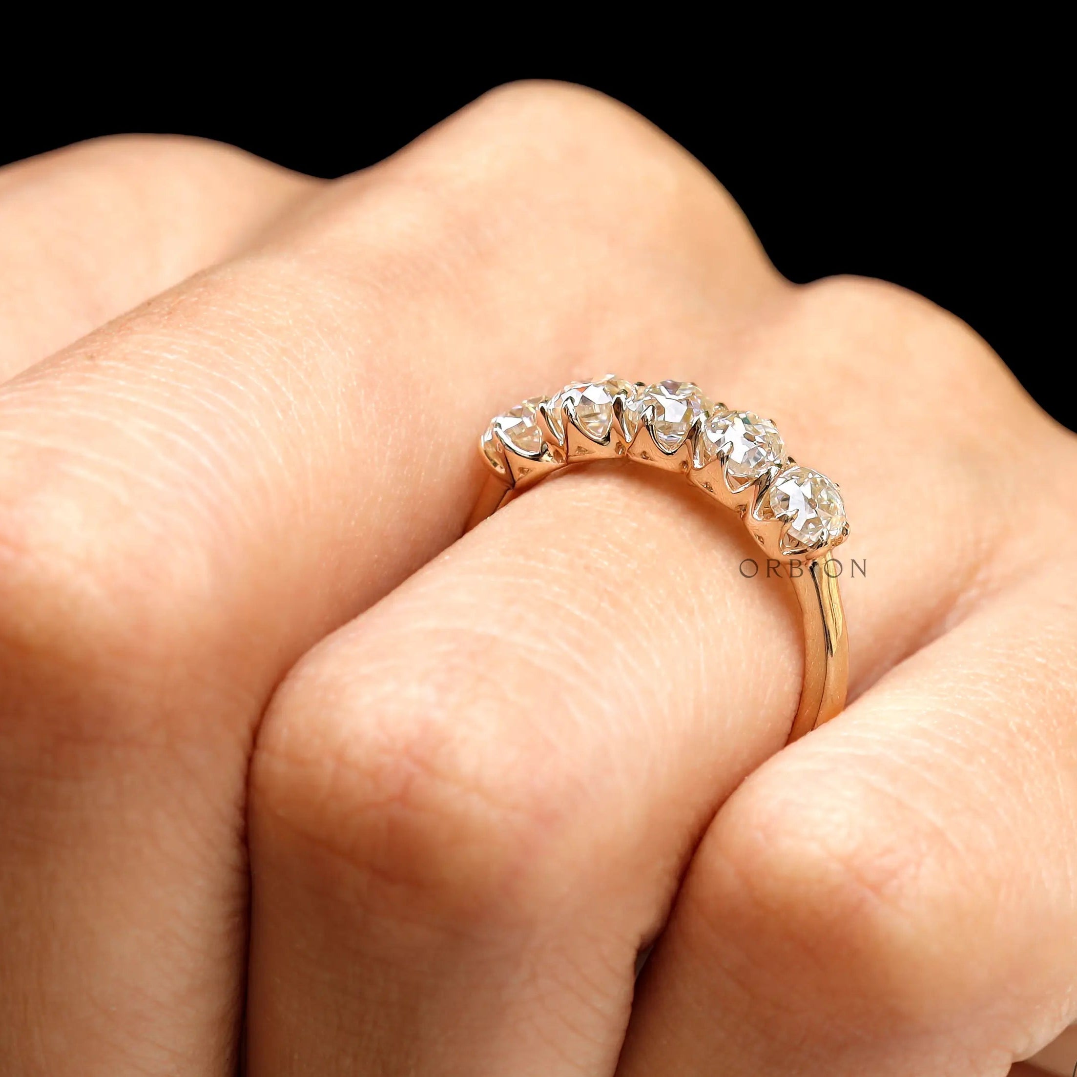 On-hand top view of five stone old mine cut cushion moissanite ring