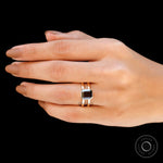 Moissanite Solitaire Elongated Asscher ring with 14K yellow gold band on display