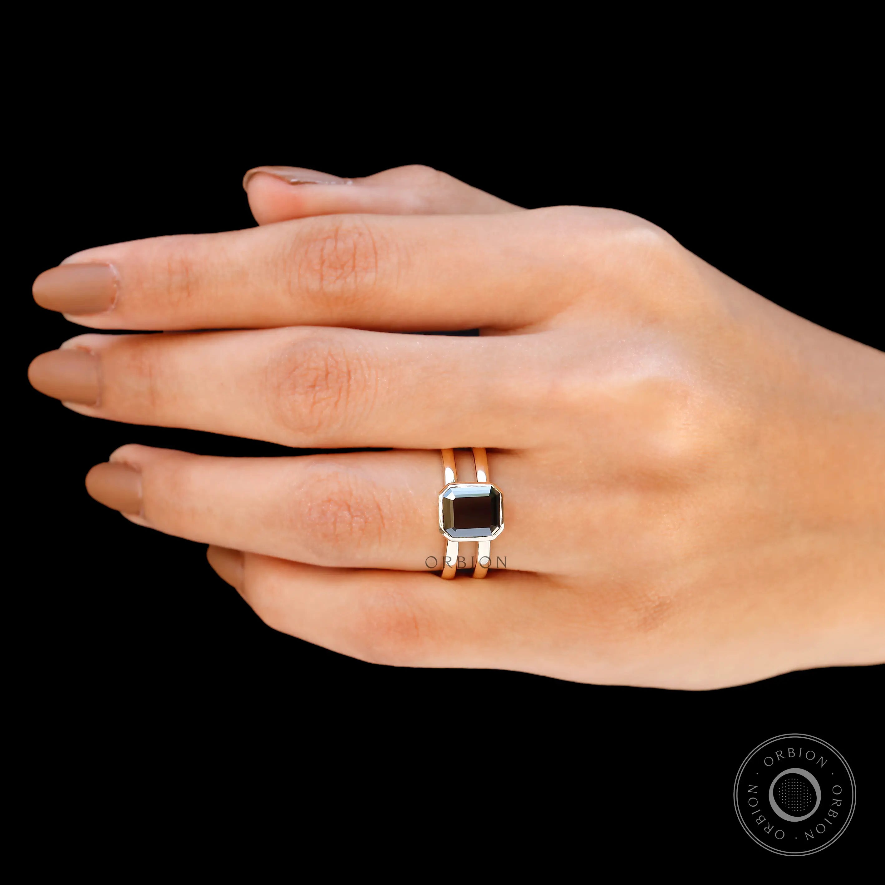 Moissanite Solitaire Elongated Asscher ring with 14K yellow gold band on display