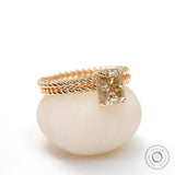 Champagne moissanite ring set on twisted rope band from the side view