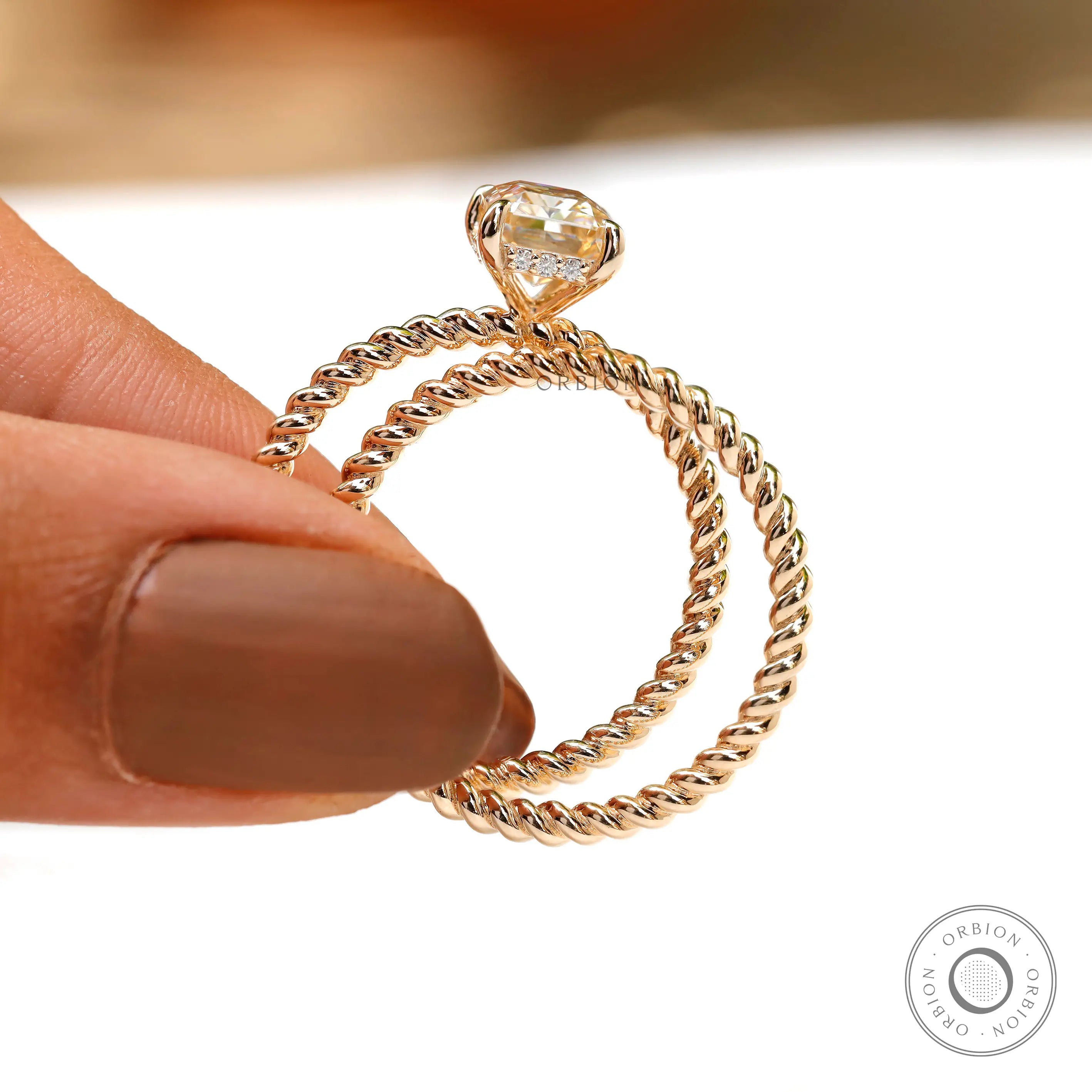 Profile shot of radiant champagne moissanite hidden halo ring