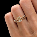 Close up worn view of champagne moissanite ring set on twisted rope band