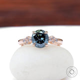 Round bluish grey moissanite engagement ring in rose gold