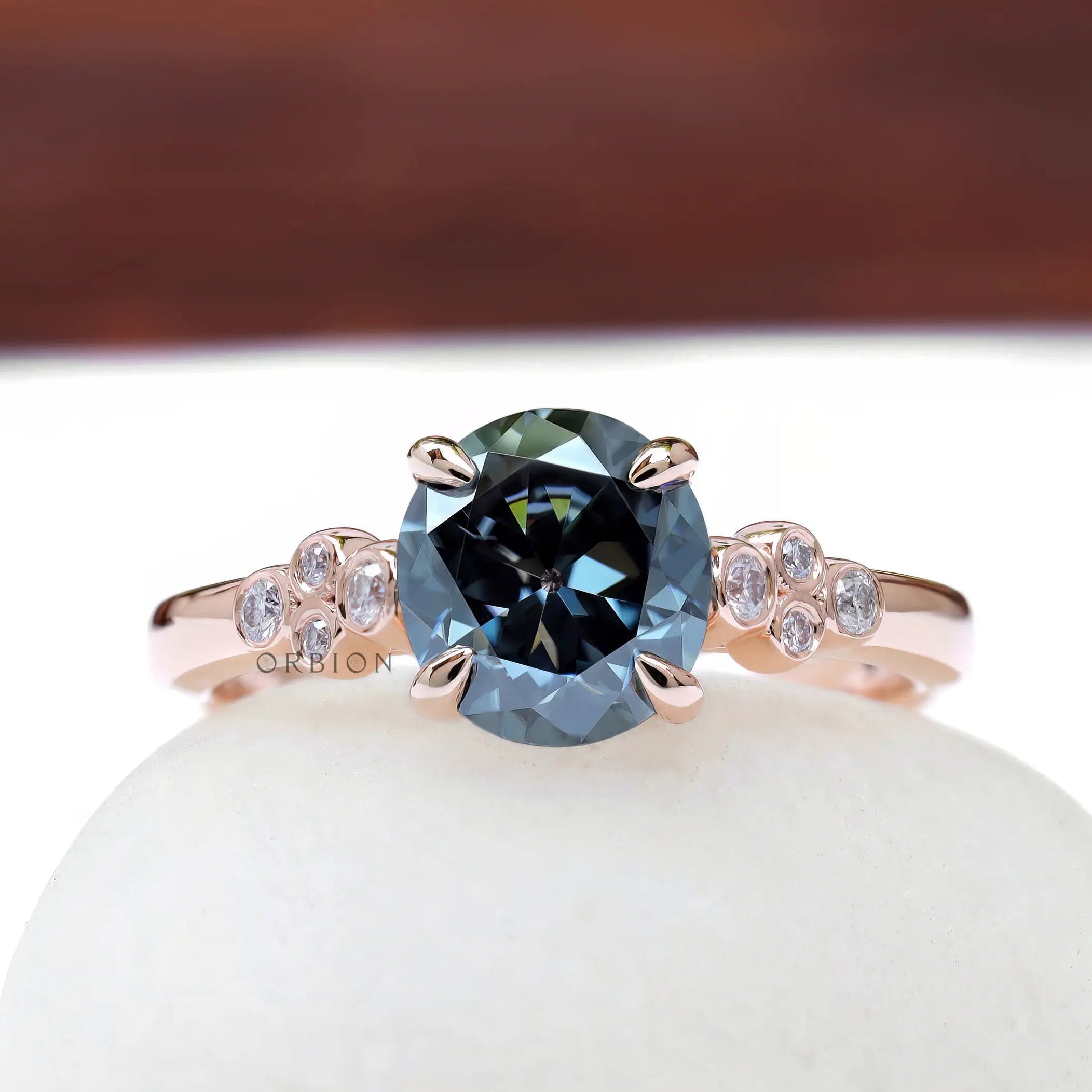 Round bluish grey moissanite engagement ring in rose gold