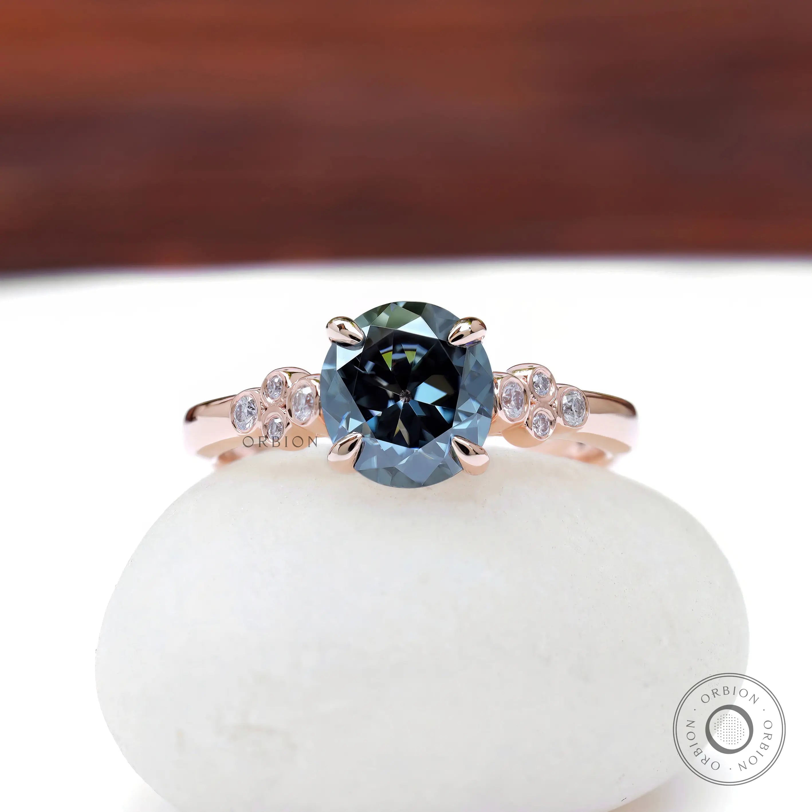 Round bluish grey moissanite engagement ring in rose gold