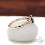 Side profile of round moissanite ring with accent stones