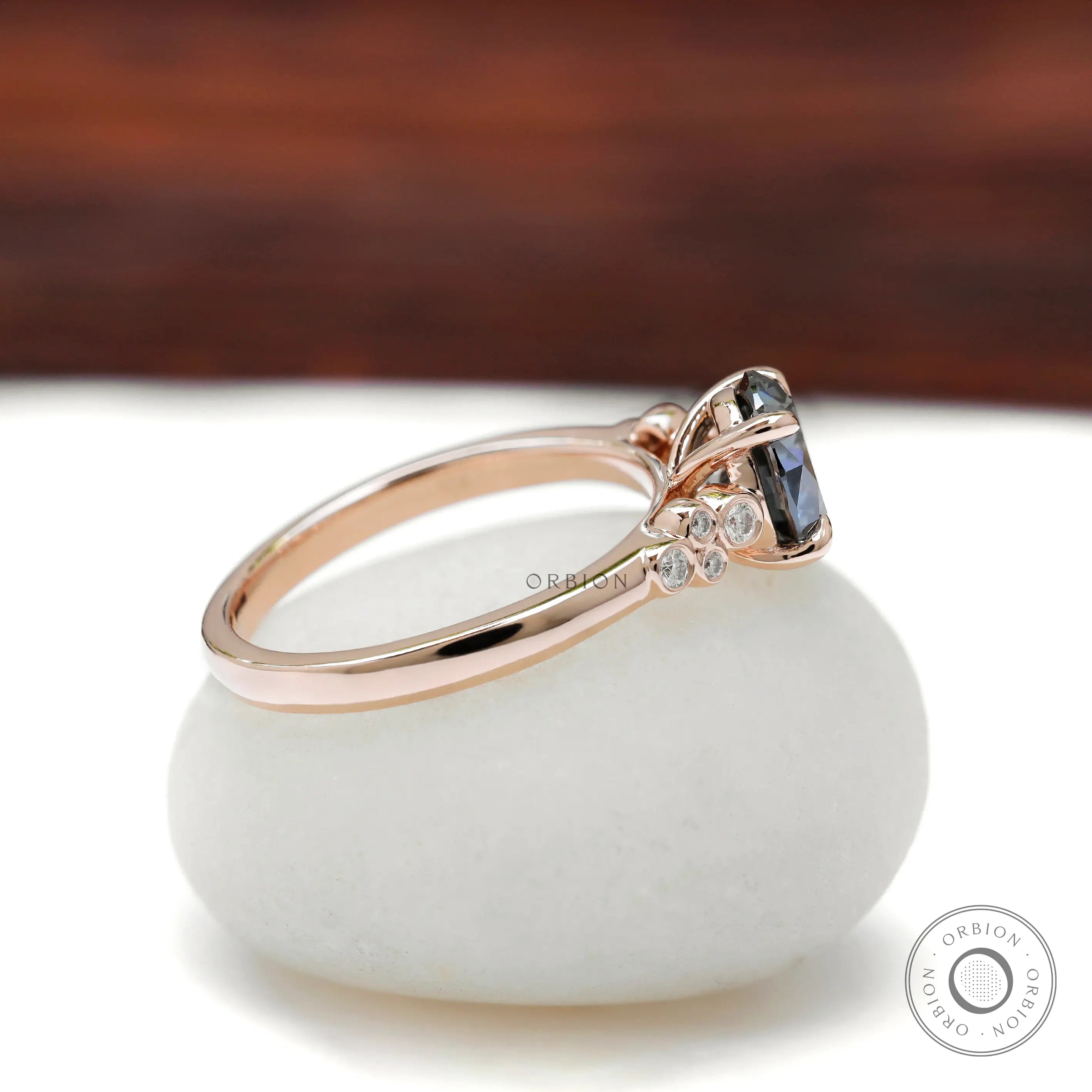 Side profile of round moissanite ring with accent stones