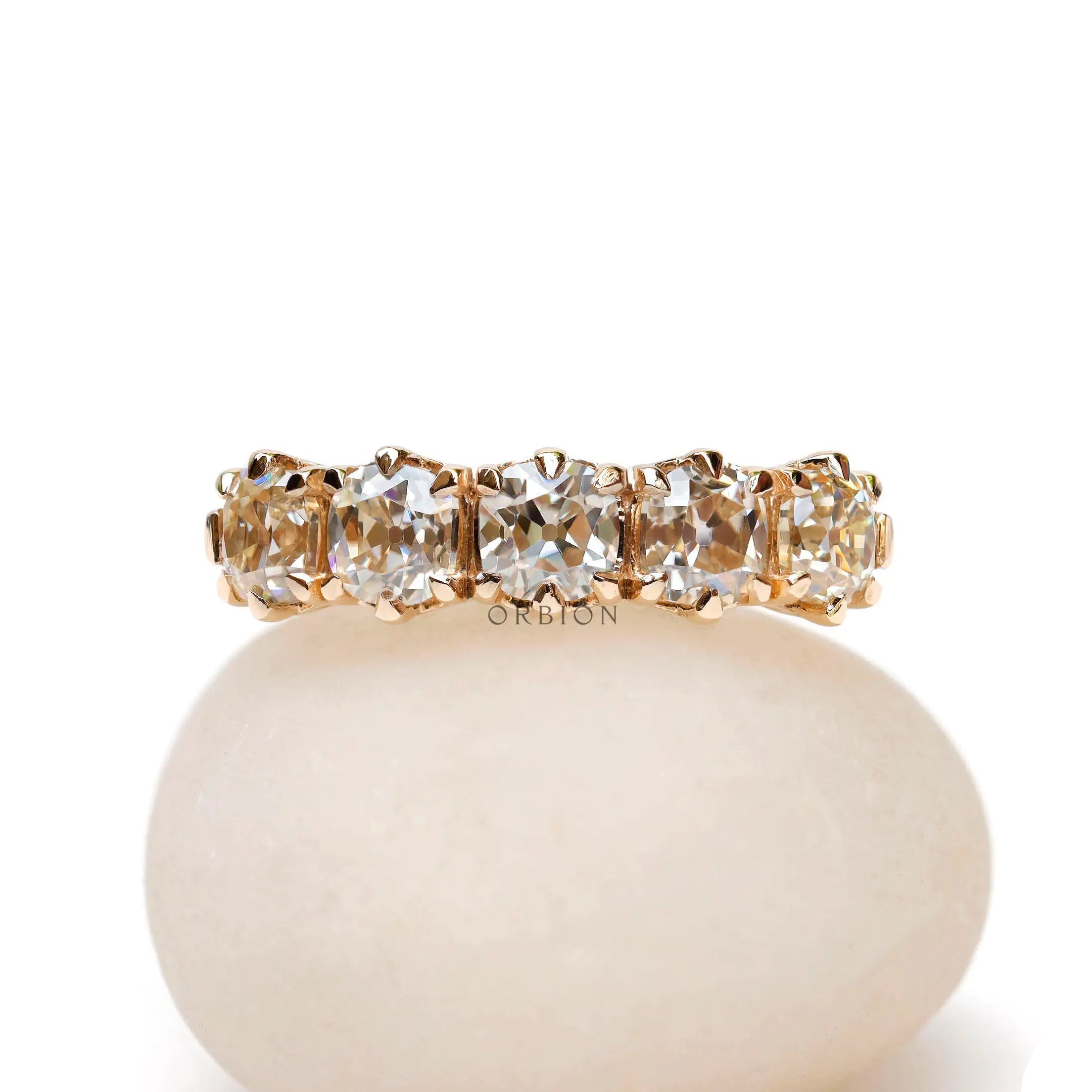 Front view of vintage five stone moissanite wedding band in solid gold