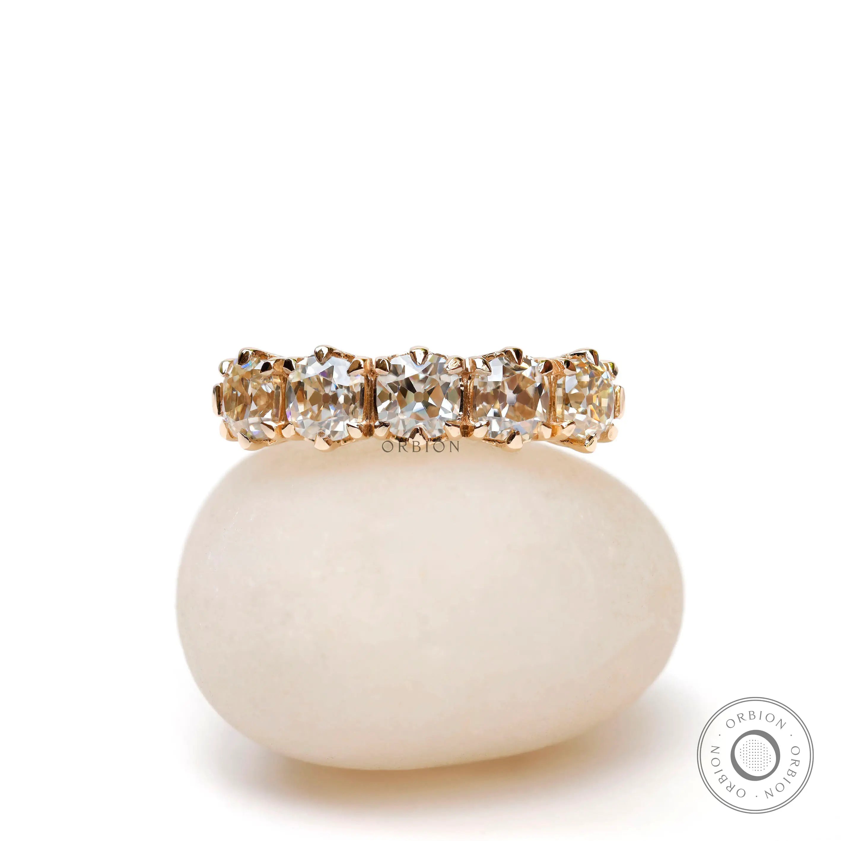Front view of vintage five stone moissanite wedding band in solid gold