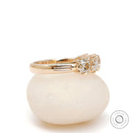 Side profile of vintage five stone moissanite band with solid gold shank