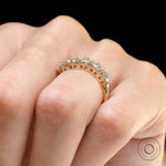 Close-up of five stone moissanite band showcasing vintage prong setting