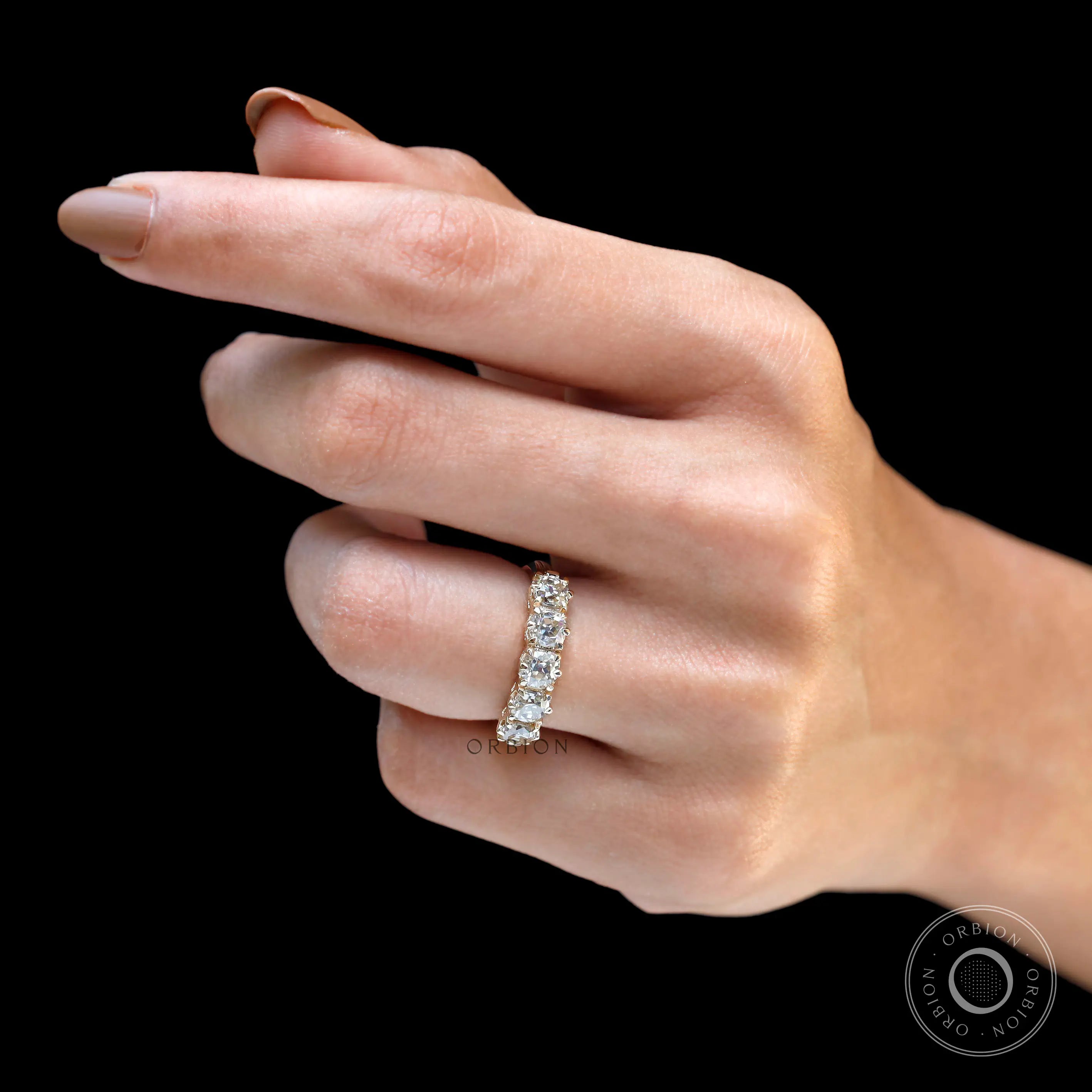 Five stone moissanite band worn on hand showing scale and sparkle