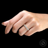 Lifestyle image of vintage five stone moissanite wedding band on finger