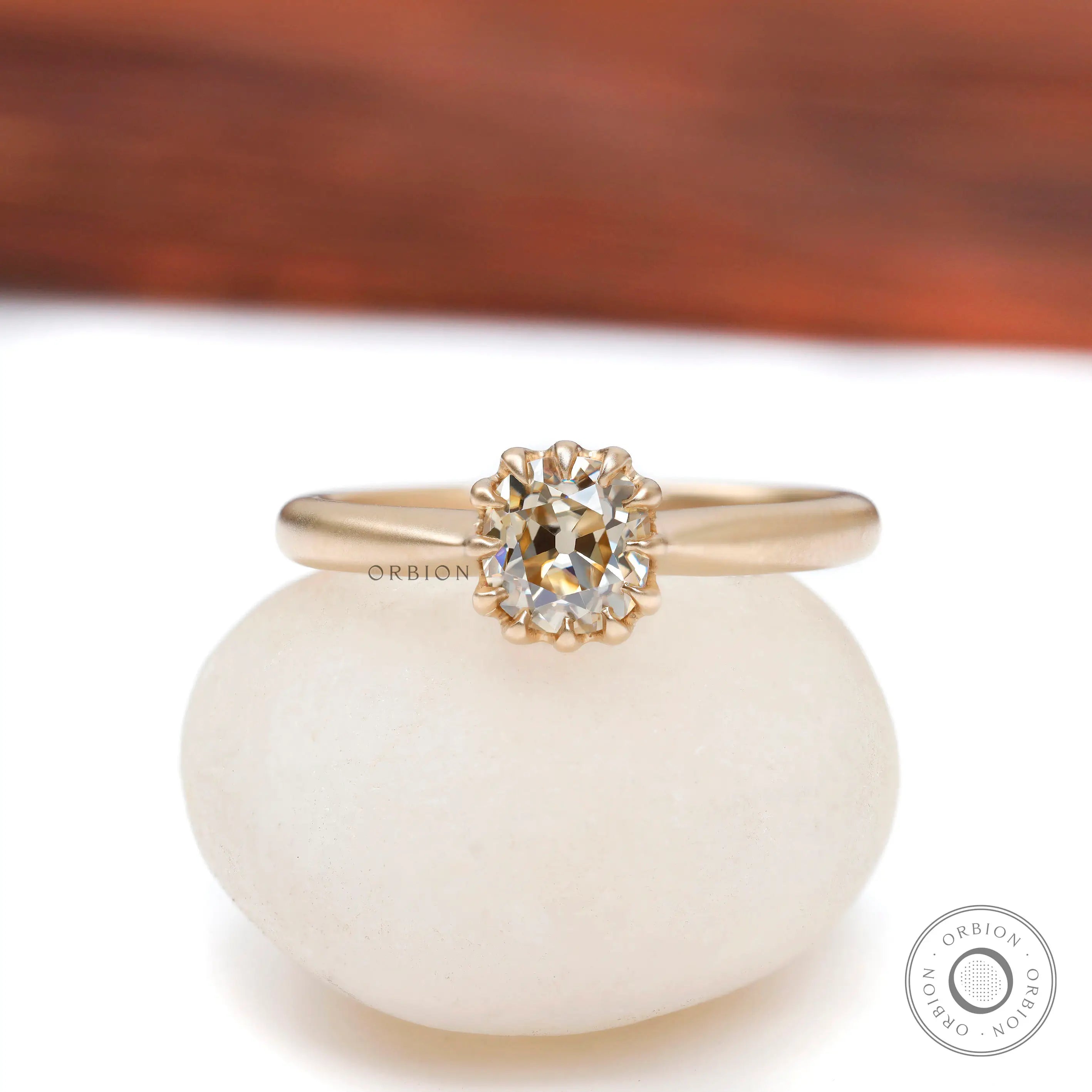 Elongated cushion Old Mine Cut light champagne moissanite solitaire ring in 10K yellow gold front view