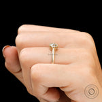 Close-up of crown-style prongs securing champagne moissanite