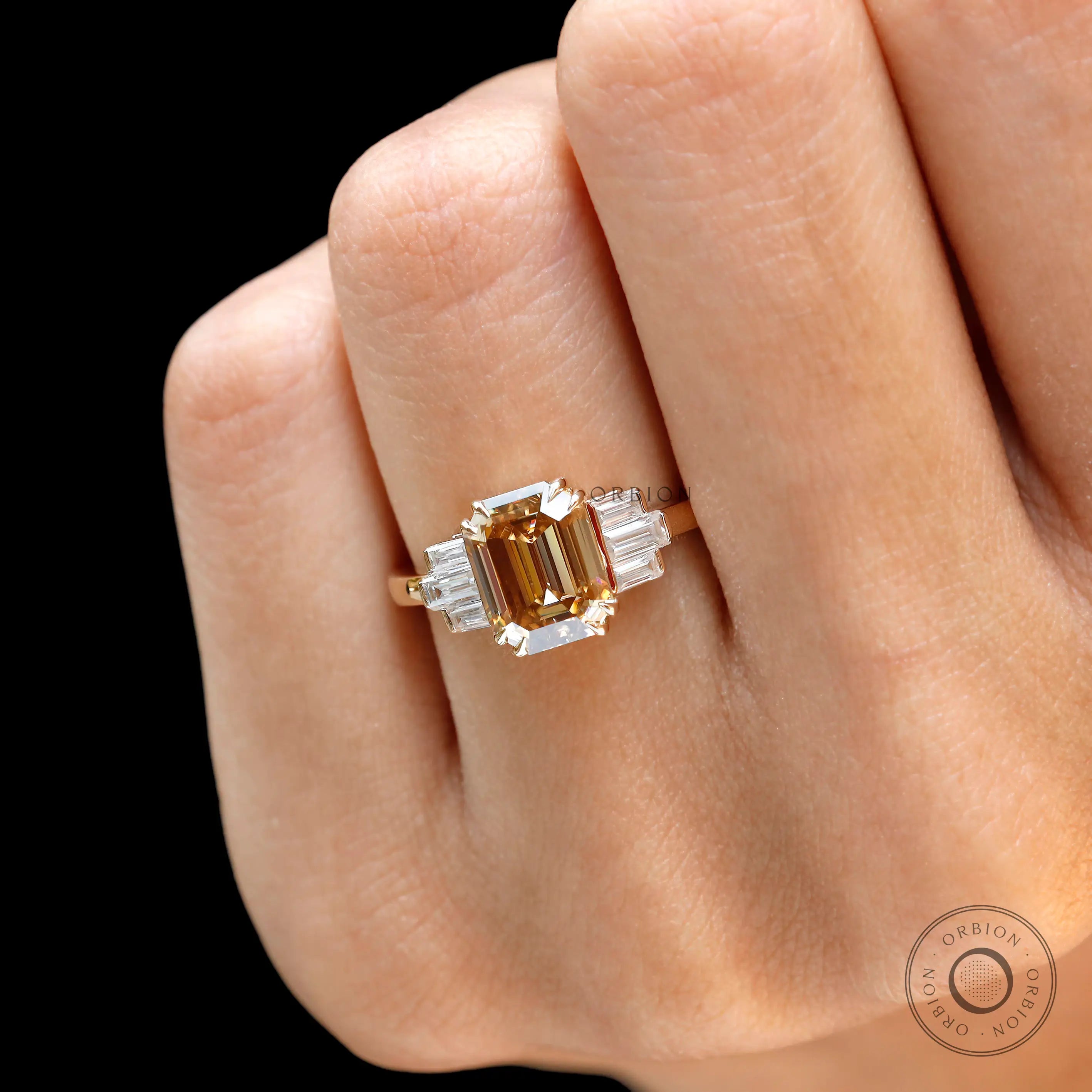 Emerald cut dark champagne moissanite cluster engagement ring yellow gold close up