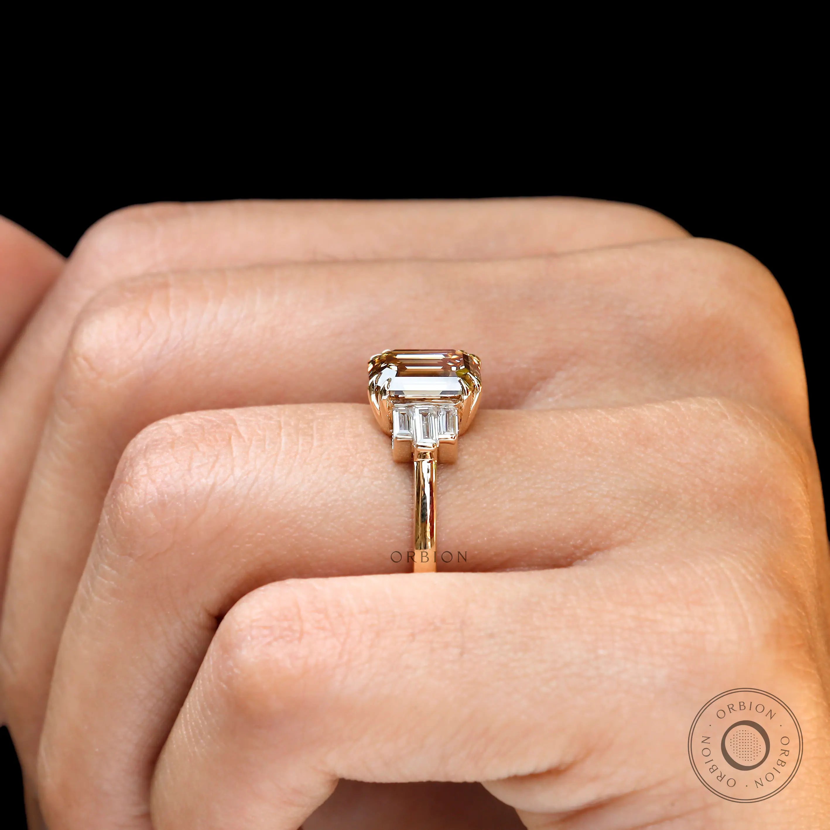 Emerald cut champagne moissanite ring side view baguette accents