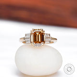 Emerald cut dark champagne moissanite engagement ring with baguette side stones