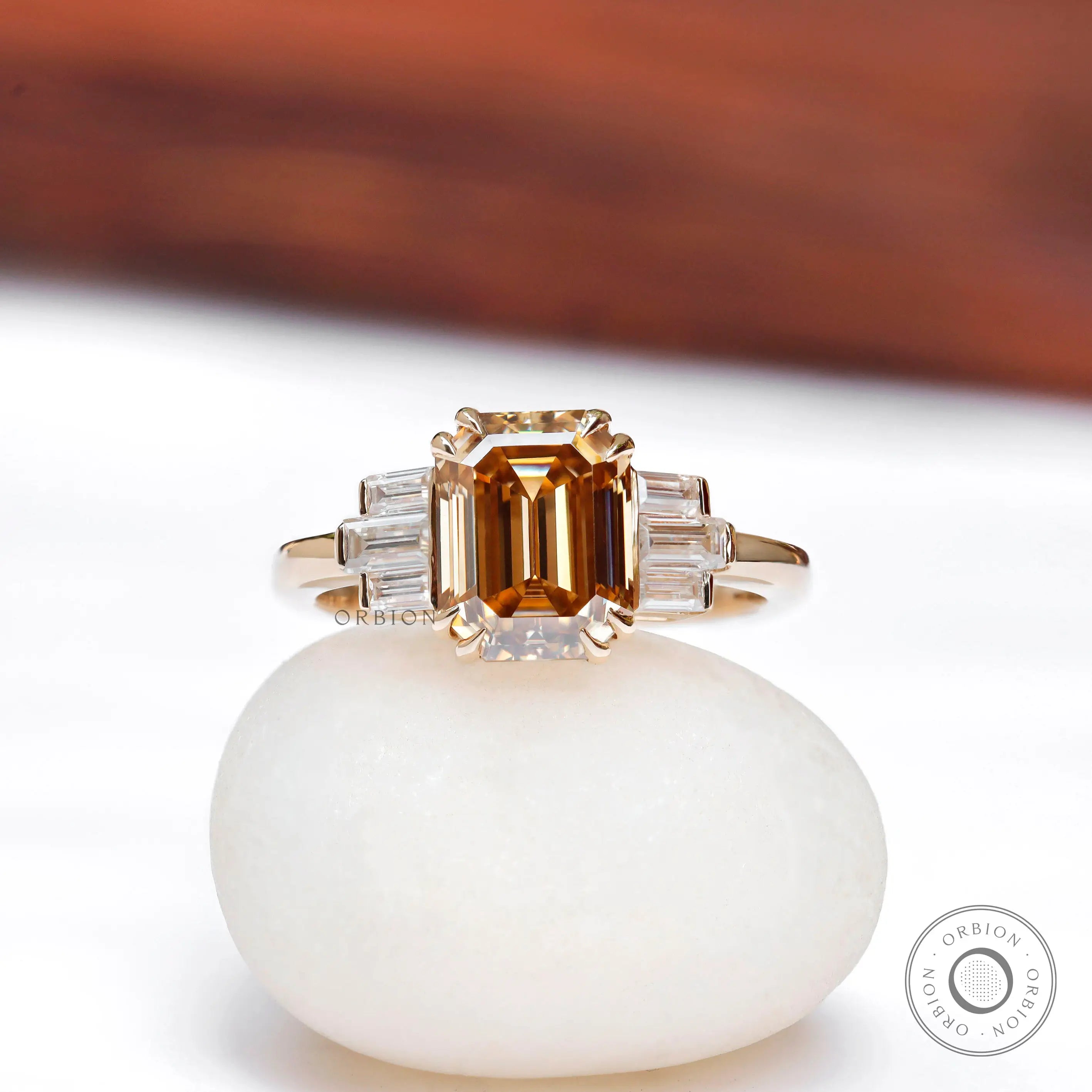 Emerald cut dark champagne moissanite engagement ring with baguette side stones