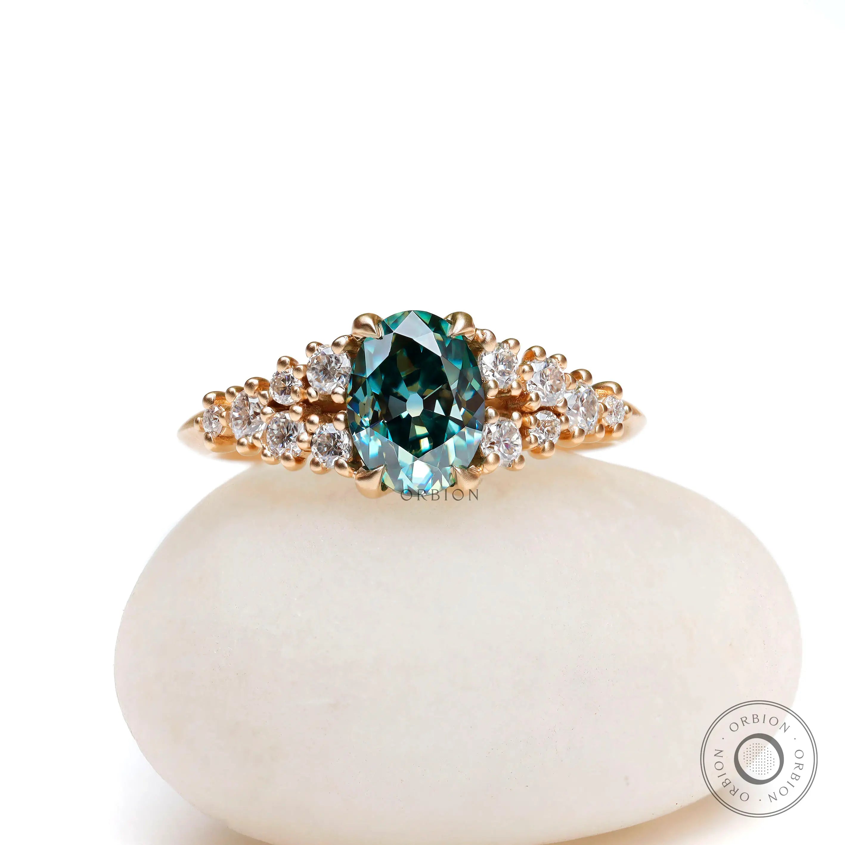 Oval blue green moissanite cluster ring in yellow gold