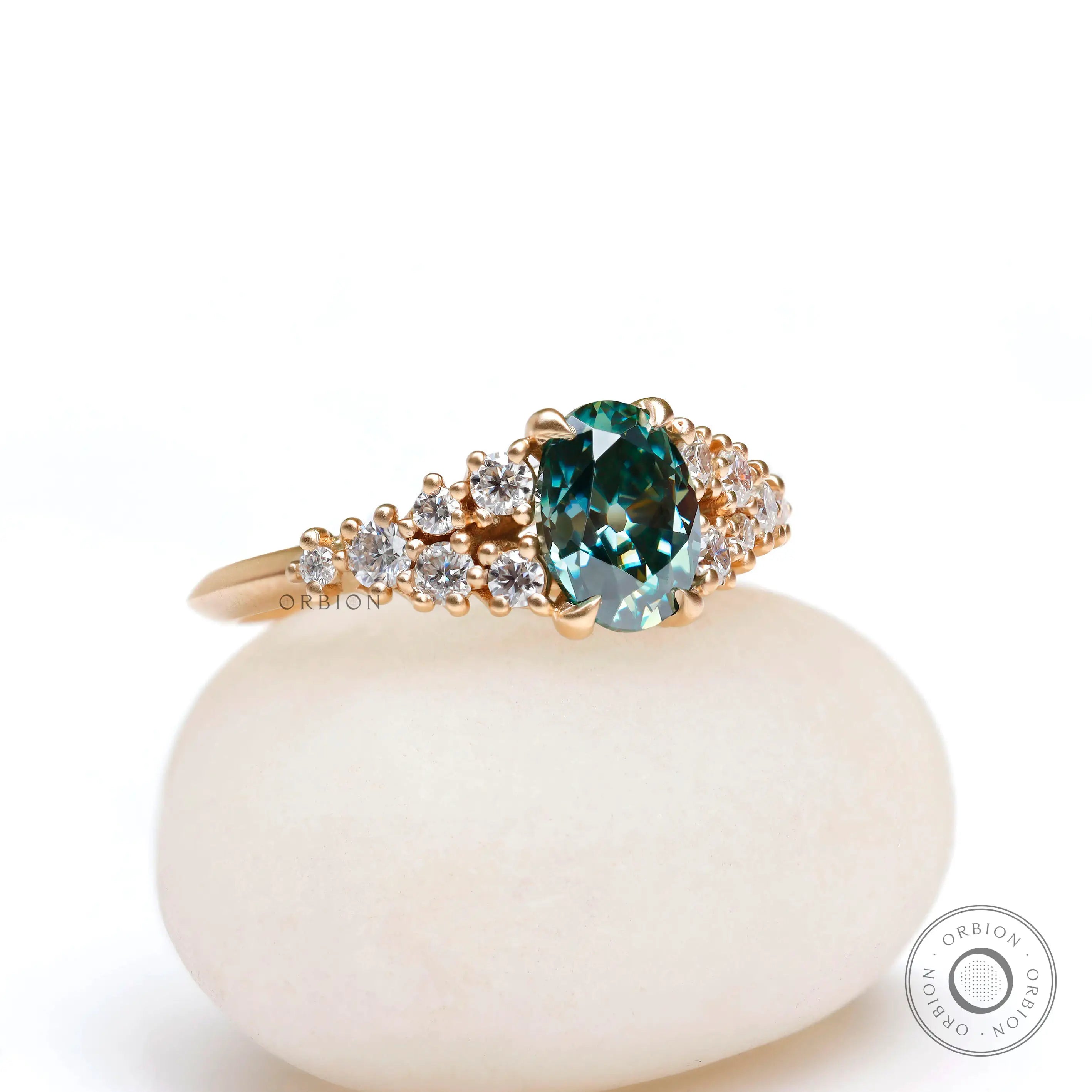 Oval moissanite ring with graduated round cluster accents