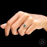 Hand worn oval blue green moissanite ring