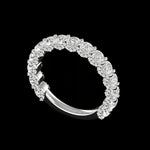 Close angled detail of shared-prong round moissanites on black background.