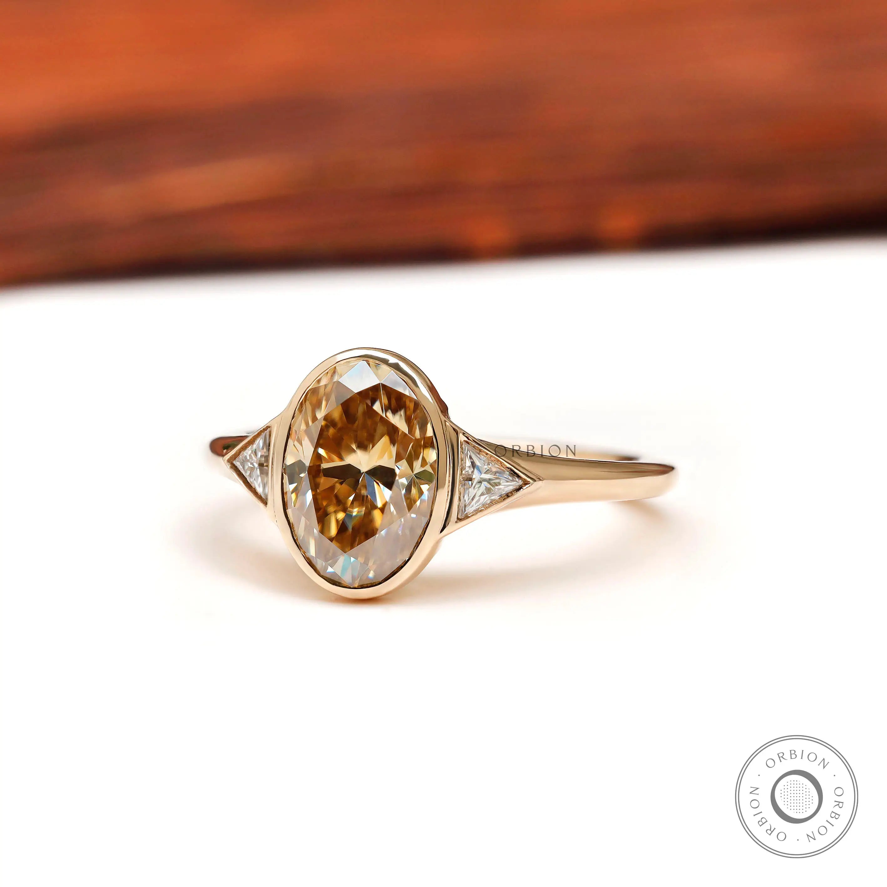 Oval champagne moissanite ring with triangle side stones